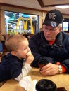 Young Toddler Boy and His Grandpa eating at Mcdonalds