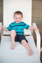 Young toddler boy on patio deck outside at sunset down at shore