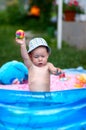 Young toddler boy playing in kiddie pool with rubber ball Royalty Free Stock Photo