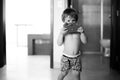 Young toddler boy playing with a wooden camera.