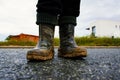 Young Toddler Exploring Nature With Muddy Boots On