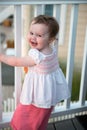 Young toddler girl on patio deck outside at sunset down at shore