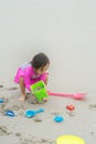 A young toddler girl is playing sand at the beach - close up photo of the sand Royalty Free Stock Photo