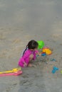 A young toddler girl is playing sand at the beach - close up photo of the sand Royalty Free Stock Photo