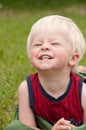 A young toddler smiles big in the yard Royalty Free Stock Photo