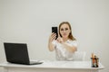 Young top manager in the office, at his workplace holding a phone in his hand and talking by video. The top manager Royalty Free Stock Photo