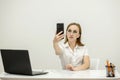 Young top manager in the office, at his workplace holding a phone in his hand and talking by video. The top manager Royalty Free Stock Photo