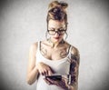 Young tough woman with tattoos reading