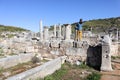 Young tourist boy with the camera on the ruins of ancient city Perge near Antalya, Turkey Royalty Free Stock Photo