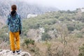 Young tourist boy looking to the ruins of ancient Pisidian city Termessos in Turkey Royalty Free Stock Photo