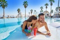 Young couple on infinity pool cocktails Royalty Free Stock Photo