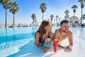 Young couple on infinity pool cocktails Royalty Free Stock Photo