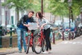 Young tourists couple looking at map in european city. Family of two on vacation in Amsterdam