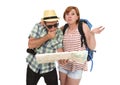 Young tourist couple reading city map looking lost and confused loosing orientation with girl carrying travel backpack Royalty Free Stock Photo