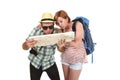 Young tourist couple reading city map looking lost and confused loosing orientation with girl carrying travel backpack Royalty Free Stock Photo