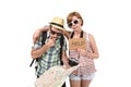 Young tourist couple reading city map looking lost and confused loosing orientation with girl carrying travel backpack Royalty Free Stock Photo