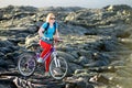 Young tourist cycling on lava field on Hawaii. Female hiker heading to lava viewing area at Kalapana on her bike. Tourist on hike