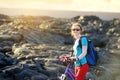 Young tourist cycling on lava field on Hawaii. Female hiker heading to lava viewing area at Kalapana on her bike. Tourist on hike