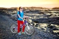 Young tourist cycling on lava field on Hawaii. Female hiker heading to lava viewing area at Kalapana on her bike. Tourist on hike