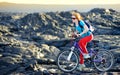 Young tourist cycling on lava field on Hawaii. Female hiker heading to lava viewing area at Kalapana on her bike. Tourist on hike