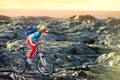 Young tourist cycling on lava field on Hawaii. Female hiker heading to lava viewing area at Kalapana on her bike. Tourist on hike