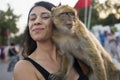 Young tourist enjoying a monkey in Jemaa el Fna square in Marrakech in Morocco Royalty Free Stock Photo