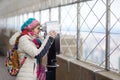 Young tourist enjoying the view of New York though binoculars Royalty Free Stock Photo