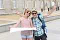 Young tourist friends couple visiting Madrid in Spain together smiling happy and relaxed