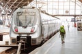 Tourist girl with backpack waits for train on railway station