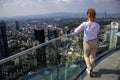 Young tourist girl with looking at the Frankfurt from the top of the main tower. Aerial View Frankfurt am Main from main tower to