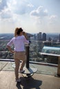 Young tourist girl with looking at the Frankfurt from the top of the main tower. Aerial View Frankfurt am Main from main tower to