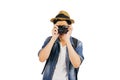 Young tourist with hat and sunglasses smiling and holding camera isolated over white background Royalty Free Stock Photo
