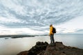 Young tourist male hiker standing on top of mountain looking at Titicaca lake Royalty Free Stock Photo