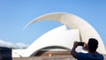 Young tourist male looking at the view and taking photos of landmarks in Tenerife, Spain