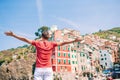 Young tourist man with great view of stunning village of Manarola, Cinque Terre, Liguria, Italy Royalty Free Stock Photo