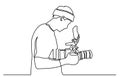 Young tourist man photographer with a camera takes pictures. One line drawing isolated vector object by hand on a white background