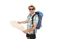 Young tourist man reading city map looking relaxed and happy carrying backpack wearing summer hat Royalty Free Stock Photo