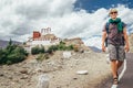 Young tourist man walks on road near Thiksey Monastery in India, Ladakh Royalty Free Stock Photo