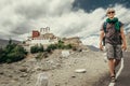 Young tourist man walks on road near Thiksey Monastery in India, Ladakh Royalty Free Stock Photo