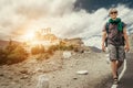 Young tourist man walks on road near Thiksey Monastery in India, Ladakh Royalty Free Stock Photo