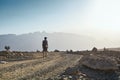 Young tourist on mountain road at sunset