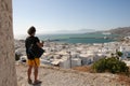Young tourist observes panorama in Mykonos Greece