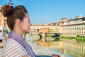 Young tourist standing on embankment overlooking Ponte Vecchio Royalty Free Stock Photo