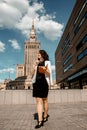 Young tourist with suitcase against Palace of Culture and Science - Warsaw - Stock Editorial Photography Royalty Free Stock Photo