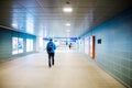 Young tourist walking in a railway station tunnel