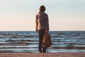 Young tourist woman with backpack looking to sea Royalty Free Stock Photo