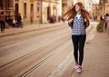 Young tourist woman with backpack walk by street in old europe city, summer fashion style Royalty Free Stock Photo