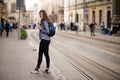 Young tourist woman with backpack walk by street in old europe city, summer fashion style Royalty Free Stock Photo