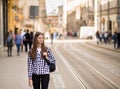 Young tourist woman with backpack walk by street in old europe city, summer fashion style Royalty Free Stock Photo