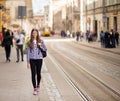 Young tourist woman with backpack walk by street in old europe city, summer fashion style Royalty Free Stock Photo